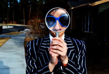 Man-holding-magnifying-glass