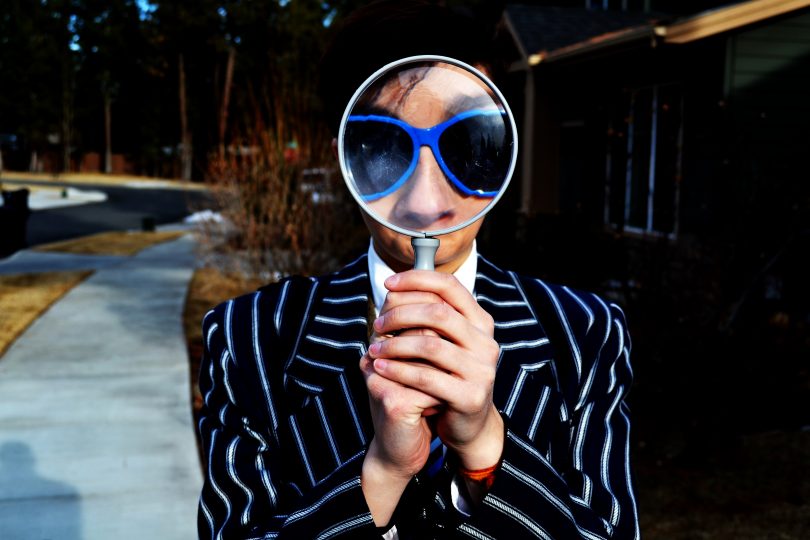 Man-holding-magnifying-glass